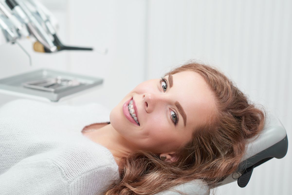 Happy,Young,Ginger,Haired,Woman,With,Braces,Smiling,To,The What Do Braces Feel Like