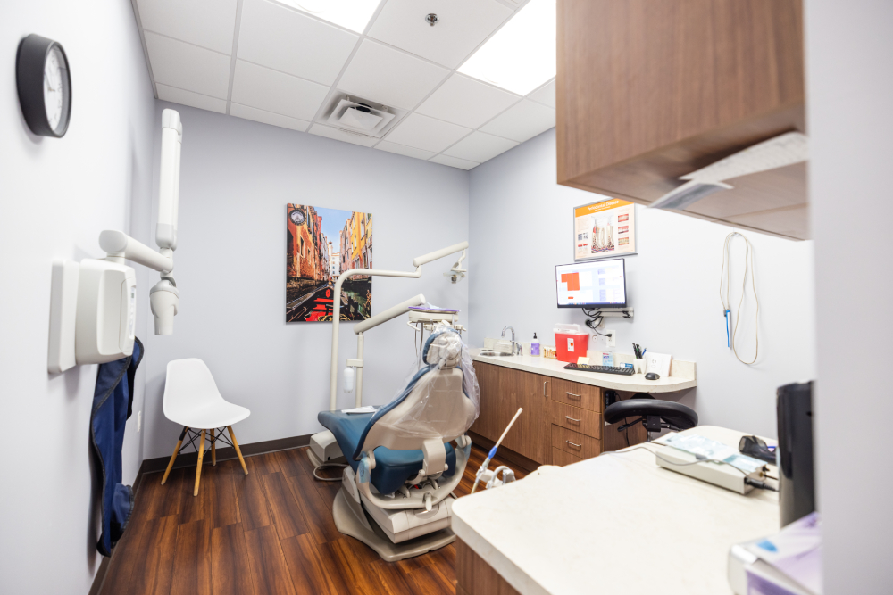img slider photo 5 new Modern dental examination room with chair, equipment, and wooden cabinetry at Kind Family Dentistry.