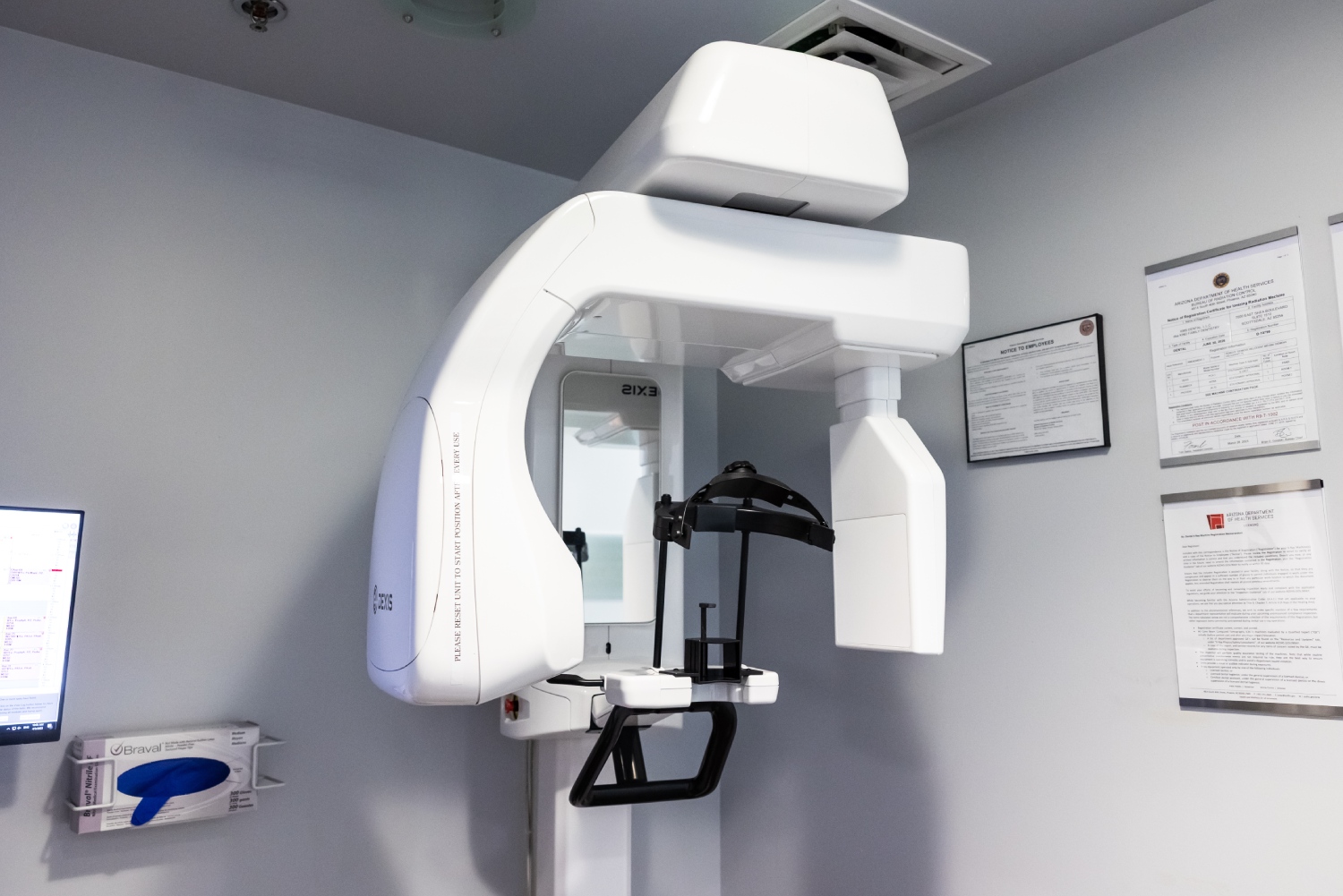 img slider photo 10 Modern dental X-ray machine in a bright clinical treatment room at Kind Family Dentistry.
